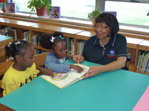 Anna McClenney, Micah Volunteer, reads with students